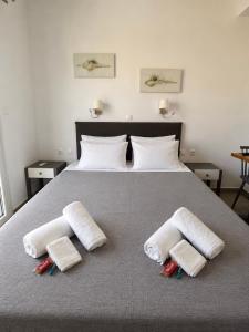 a bedroom with a large bed with two towels on it at La isla in Naxos Chora