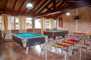 two ping pong tables in a room with at Cabañas Costa Alta in Mina Clavero