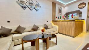 a living room with a couch and a table at Hotel Almou in Ouarzazate