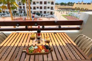 a plate of food on a table on a balcony at Casa Avina Bliss in Los Alcázares