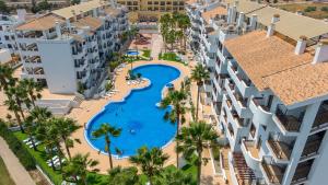 an aerial view of a resort with a swimming pool and palm trees at Casa Avina Bliss in Los Alcázares