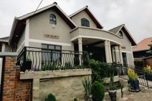 a house with a balcony with a sign on it at Sabyinyo Crest in Cyuve