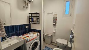 a small bathroom with a toilet and a sink at Casa Rose in Villaggio Azzurro +6 photos