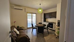 a living room with a couch and a table at Casa Rose in Villaggio Azzurro