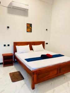 a bedroom with a bed in a room at The Royal Ember in Arugam Bay