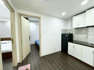 a room with a kitchen and a bedroom with a bed at DLux Saigon Condo in Ho Chi Minh City +17 photos