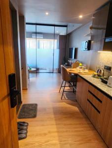 a kitchen and living room with a table and chairs at Elite Haven in Raipur