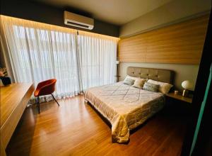 a bedroom with a bed and a desk and a chair at Elite Haven in Raipur