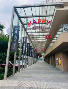 a walkway outside of a shopping mall with a happy sign at Elite Haven in Raipur