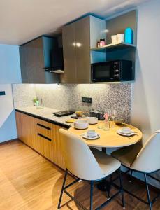 a kitchen with a table and chairs in a kitchen at Elite Haven in Raipur
