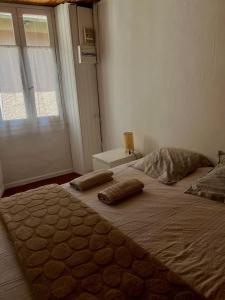 a bedroom with a large bed with two pillows on it at Charmant in Saint-Martin-Vésubie +5 photos