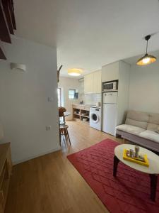 a living room with a couch and a table at Casa dos Pintos in Paredes de Coura
