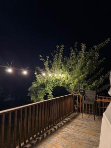 a string of lights on a deck at night at Skyla Glamping in Ambrolauri