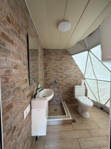 a bathroom with a sink and a toilet at Skyla Glamping in Ambrolauri