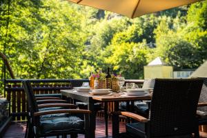 a table and chairs on a patio with trees at Chalupa 47 in Hřensko
