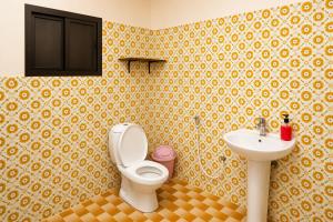 a bathroom with a toilet and a sink at Liva Residency in Salalah