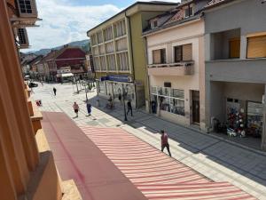 a group of people walking down a street at LUX Apartmani Dubrava in Ivanjica