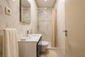 a bathroom with a sink and a toilet and a shower at Imperial apartment 1, 2 e 3 in Braga +35 photos