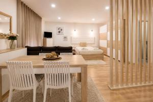 a living room with a table and chairs and a couch at Imperial apartment 1, 2 e 3 in Braga