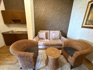 a living room with two chairs and a couch at LUX Apartmani Dubrava in Ivanjica
