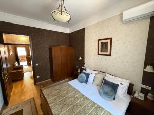 a bedroom with a bed with blue pillows at LUX Apartmani Dubrava in Ivanjica +40 photos