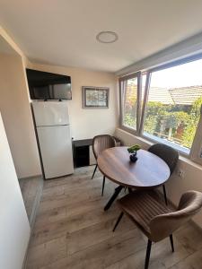 a living room with a table and a refrigerator at Irene in Pawlikeni