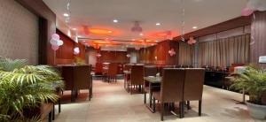 a restaurant with tables and chairs and pink balloons at Sparsh Hotel & Resort in Bareilly