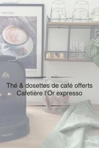 a shelf with a cup of coffee and a picture at La maison du Maréchal in Parthenay