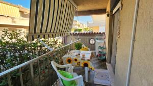 a balcony with a table and chairs on a balcony at Casa Rose in Villaggio Azzurro