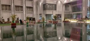 a large building with a pool of water in the middle at Sparsh Hotel & Resort in Bareilly