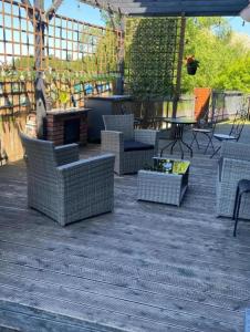 a patio with wicker chairs and a fire place at Lumen in Krakow
