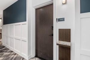 a door leading into a room with white cabinets at Upscale Condo In Annapolis w/Private Parking in Annapolis