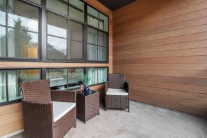 a patio with two chairs and a table in a building at Upscale Condo In Annapolis w/Private Parking in Annapolis