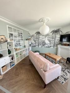 a living room with a couch and a table at La maison du Maréchal in Parthenay +15 photos