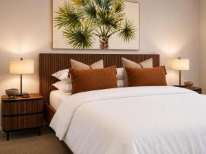 a bedroom with a large white bed and two lamps at One Mile Retreat - Ocean View 3 Bedroom Retreat in Anna Bay