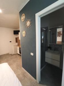 a bedroom with a door leading to a bathroom at Mercury Room in Limbiate +2 photos