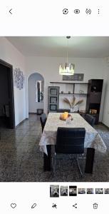 a living room with a dining room table with chairs at Renas home in Anavyssos