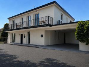 a large white house with a balcony at Residenza Ricci in Azzano San Paolo