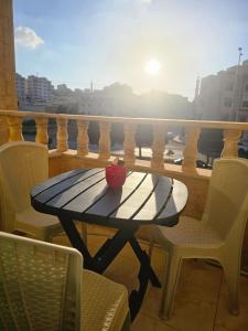 a table on a balcony with a view of a city at الجبيهه شفابدران شقة مفروشة in Amman