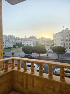 a balcony with a view of a parking lot at الجبيهه شفابدران شقة مفروشة in Amman