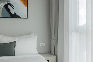a bedroom with a bed and a painting on the wall at A417-60m2-2bedroom Serenity 66935B2I976 in Nai Yang Beach