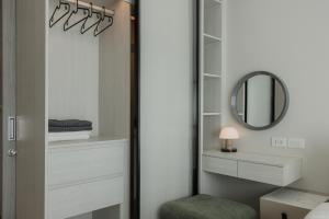 a bedroom with a closet with a mirror and a stool at A417-60m2-2bedroom Serenity 66935B2I976 in Nai Yang Beach +73 photos