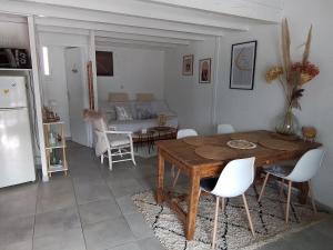a kitchen and dining room with a wooden table and chairs at style petit chalet de montagne in Prades