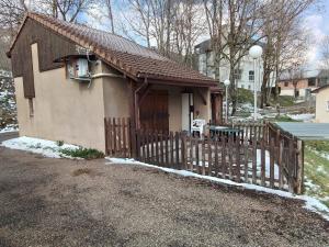 a small house with a wooden fence in front of it at style petit chalet de montagne in Prades