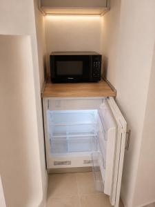 a microwave sitting on a shelf in a refrigerator at Suite Il Mulino - Sea View in Sperlonga