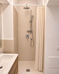 a bathroom with a shower with a shower curtain at Suite Il Mulino - Sea View in Sperlonga +11 photos