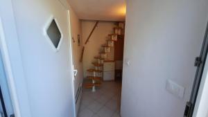 a hallway with a room with a staircase and boxes at Apartment Carolina - Hillside Stay, Steps from the Sea in Portorož +18 photos