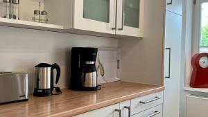 a coffee maker on a counter in a kitchen at Villa Sonneck, App 07 - Bade- & Saunawelt täglich inklusive in Ostseebad Sellin +25 photos