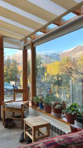 a room with a large window with potted plants at Green House B & B in Villa La Angostura