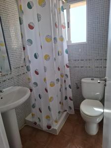 a bathroom with a toilet and a sink at Ático Playa in Cartagena +8 photos